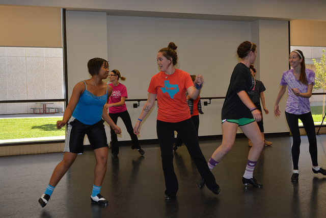 Dancers practicing a dance and laughing